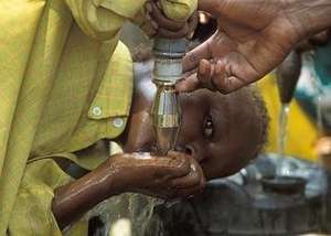 Kenya Boy Drinking Water from Spicket