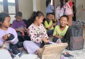 Grade 1 students receiving school supplies