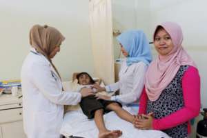 Relaxed patient with Mom looking on