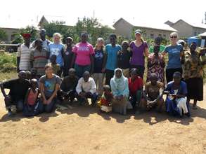 Student volunteers posing with new garden owners