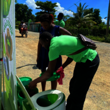 Sales team showing a demo of the EkoLakay toilet