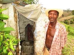 Montas next to his completed latrine.