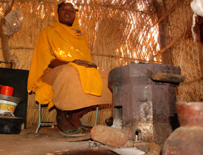 Nafisa with her new stove and chairs.