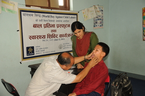 A young boy receives a thorough wellness exam.