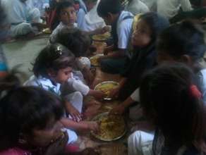 Students enjoying Mutton Biryani at the schools