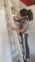 Gabriella helping paint in their house
