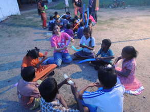 Children learning skills from the volunteers