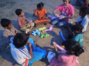 Children preparing toys from balloons