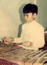 Sombat learning Roneat Ek as a young boy