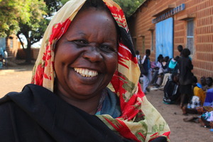 Eliza smiles as she receives food for her kids.
