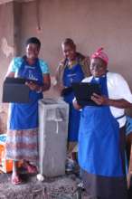 Women inspect the biosand filter for leaks