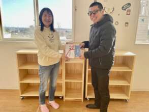 Endo-San presents book coupon to Shimura-san
