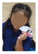 Bai Bua when she was well, showing her work of art