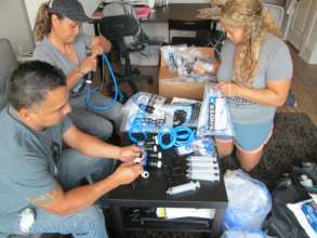 Team members assembling water filters for Colombia