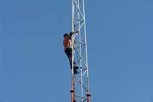 A technician on a mesh tower