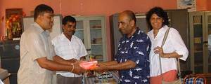 Ananda and Subadra Sirisena donating dictionaries to Thakshila P