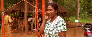 A lady uses a mobile phone in the village