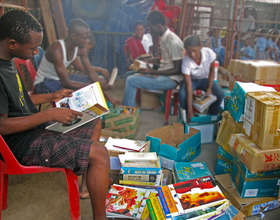 Volunteers selecting and sorting donated books for