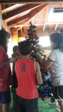 Kids gathered to put up the Christmas tree