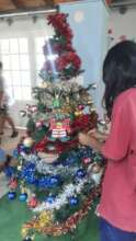 Kids gathered to put up the Christmas tree