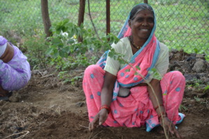 Village Health Worker planting a tree