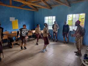 Learners being taught cultural dancing moves