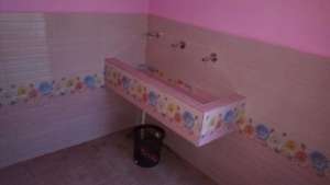 A inside view of the handwashing unit in toilet