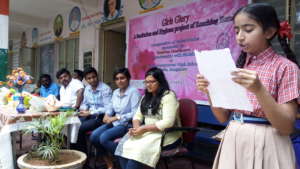 Sneha* telling the audience the benefits of WASH