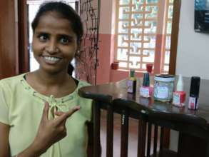 Durga happily displays the cosmetics made by her