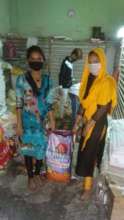 Girl Leaders in bastis distributing grocery items