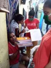Distributing Textbooks to girls in bastis