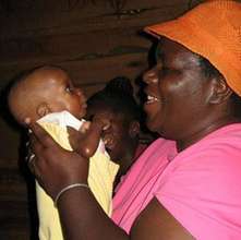 Health-care worker holds baby