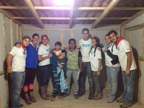 Sarah with her team in a completed house