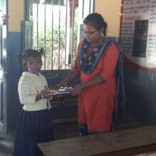 Distributing the books and stationery supplies.