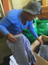 Patricia sorting through the clothes
