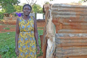 Alice shows her dilapidated outdoor shower