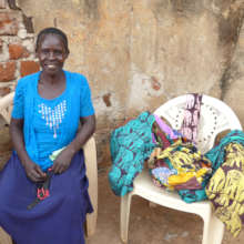Molly, Jinja business woman, with her sling bags