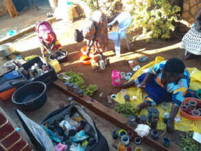 Ugandan women tie dyeing silk scarves in December