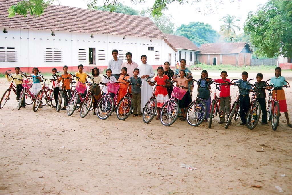 Happy boys and girls at school with their new bikes