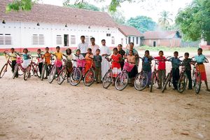 Happy boys and girls at school with their new bikes