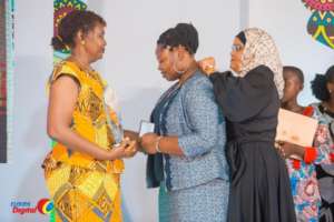 Rhobi receiving her award