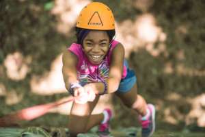 All smiles while scaling the rock wall