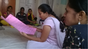 Trainee Chitra reads notes from the group work