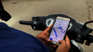 A rider using Google Maps to deliver her orders