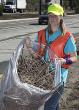Youth Manager Ashley, collecting dead plants