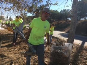 Chevron Volunteers carry debris off of the median