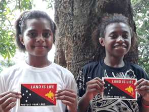 Valiant girls with Land is Life stickers