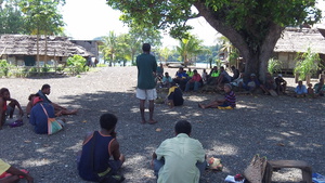 Palau (back to camera) shares seabed mining information with Karkar Islanders.JPG