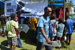 Visitors walk away from BRG stall with information and posters.JPG