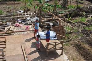 Kids playing in what remains of their house